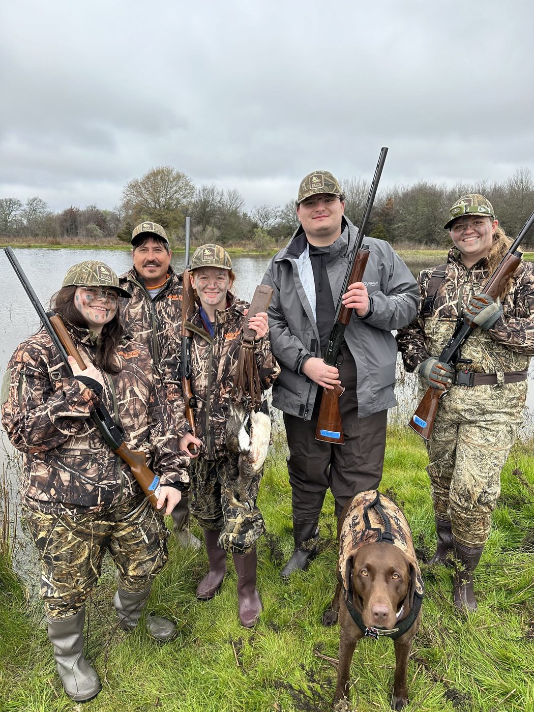 A group of hunters and the dog after a Central Texas duck hunt