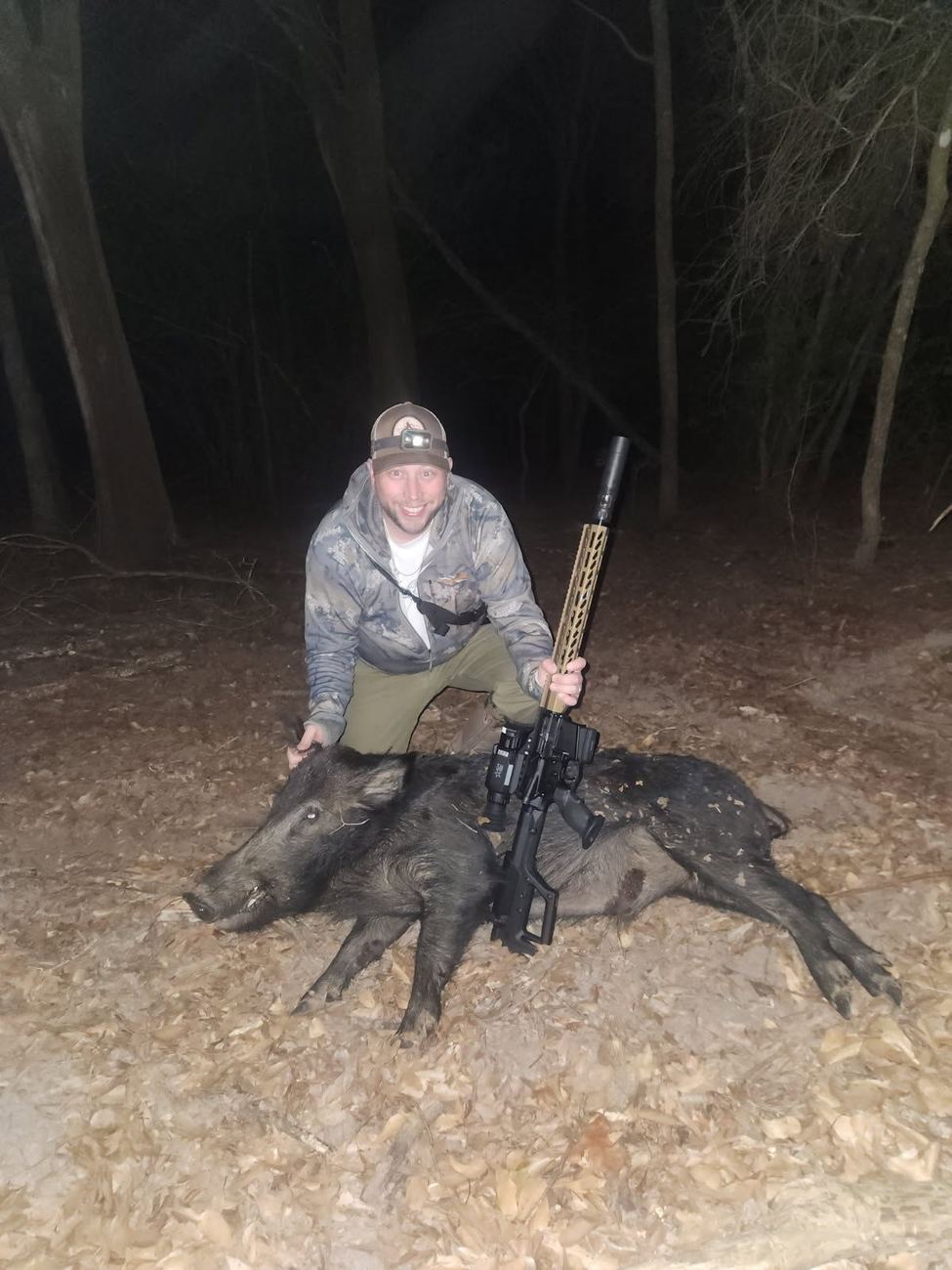 Hunter with hogs taken on a thermal night hunt